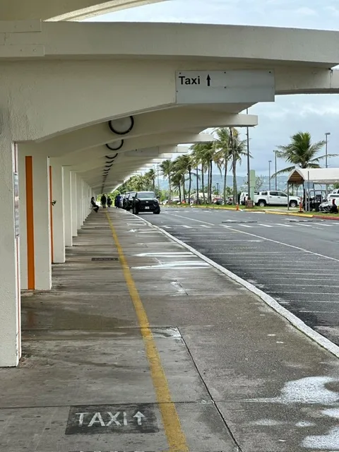 Taxi stand signs outside the arrivals area at Guam International Airport